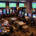 Spectators engaging in soi kèo sports betting, surrounded by live screens and vibrant casino ambiance.