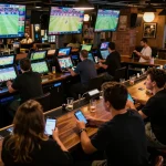 Bsport betting action at a lively sports bar with patrons engaged in real-time wagering and live game viewing.