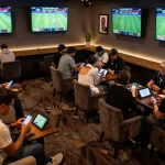 Experience exciting live sports betting action at 8live with guests engaging on their devices.